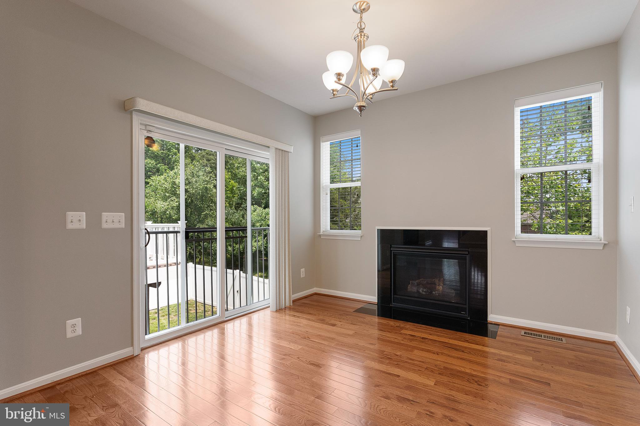 22672 Flowing Spring Square Brambleton, VA 20148 - Photo 9 of 35 a view of a livingroom with wooden floor fireplace and a window