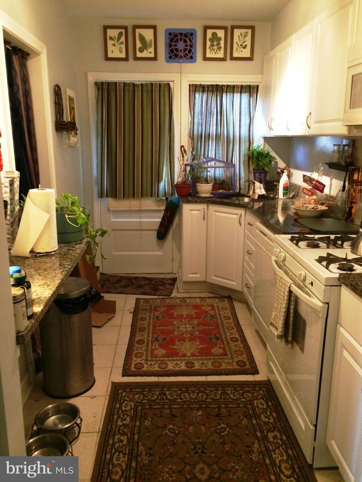 55 Burkleigh Road Towson, MD 21286 - Photo 3 of 5 a kitchen with sink a stove and a refrigerator