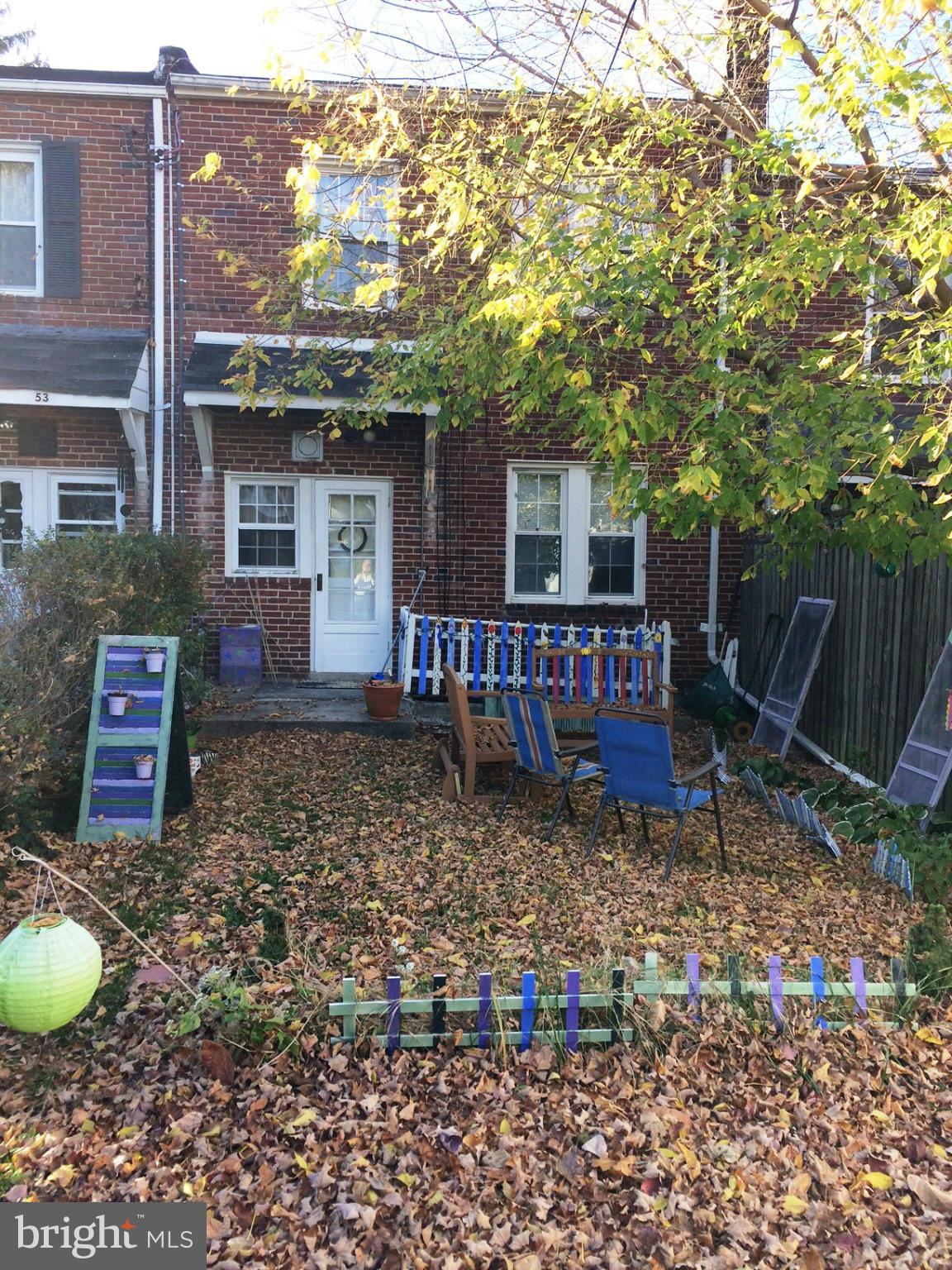 55 Burkleigh Road Towson, MD 21286 - Photo 5 of 5 a view of a house with a backyard and a tree