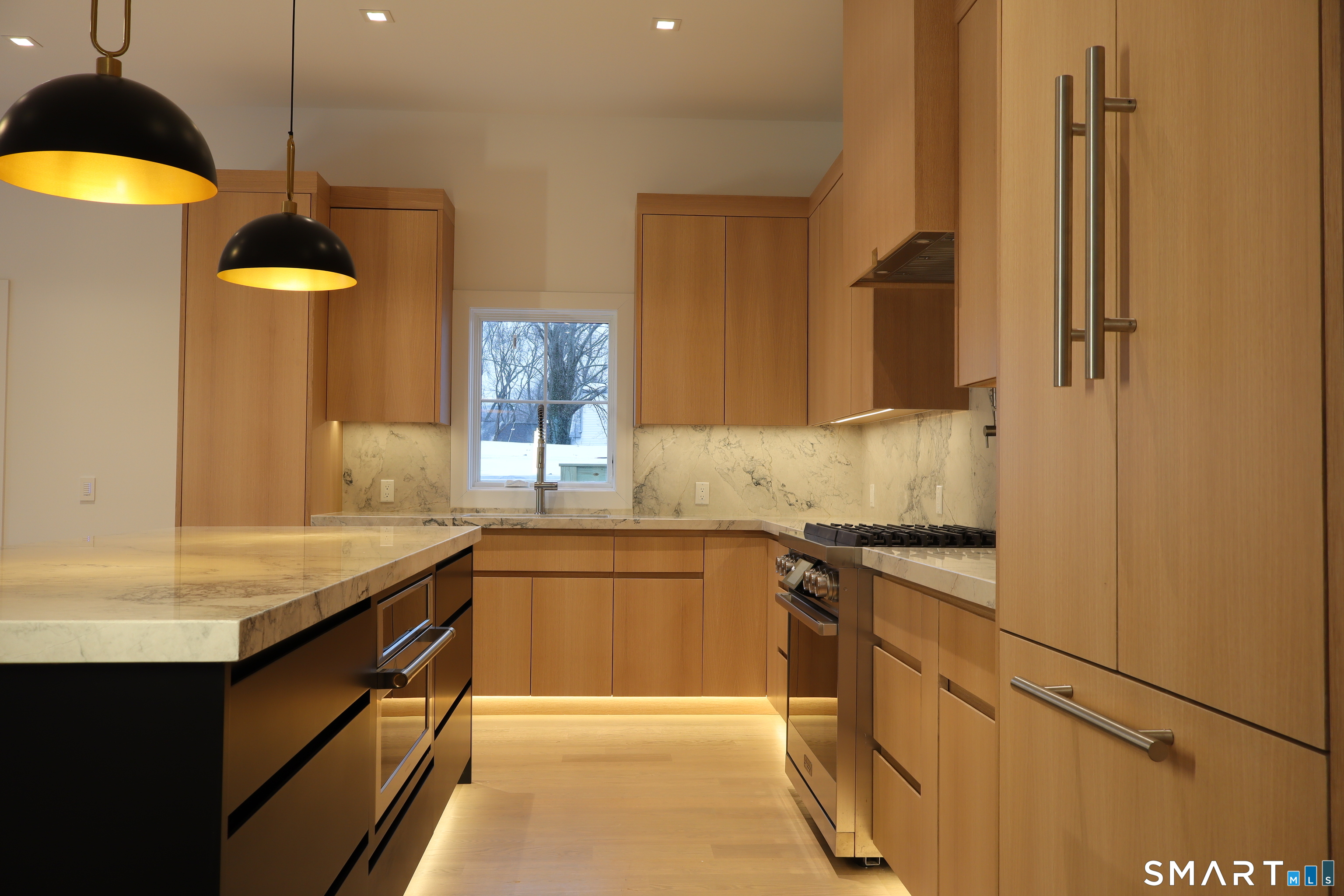 173 Belltown Road Stamford, CT 06905 - Photo 11 of 42 a kitchen with a sink a counter top space stainless steel appliances and cabinets