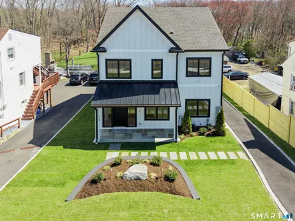 a view of a house with a yard patio and a slide