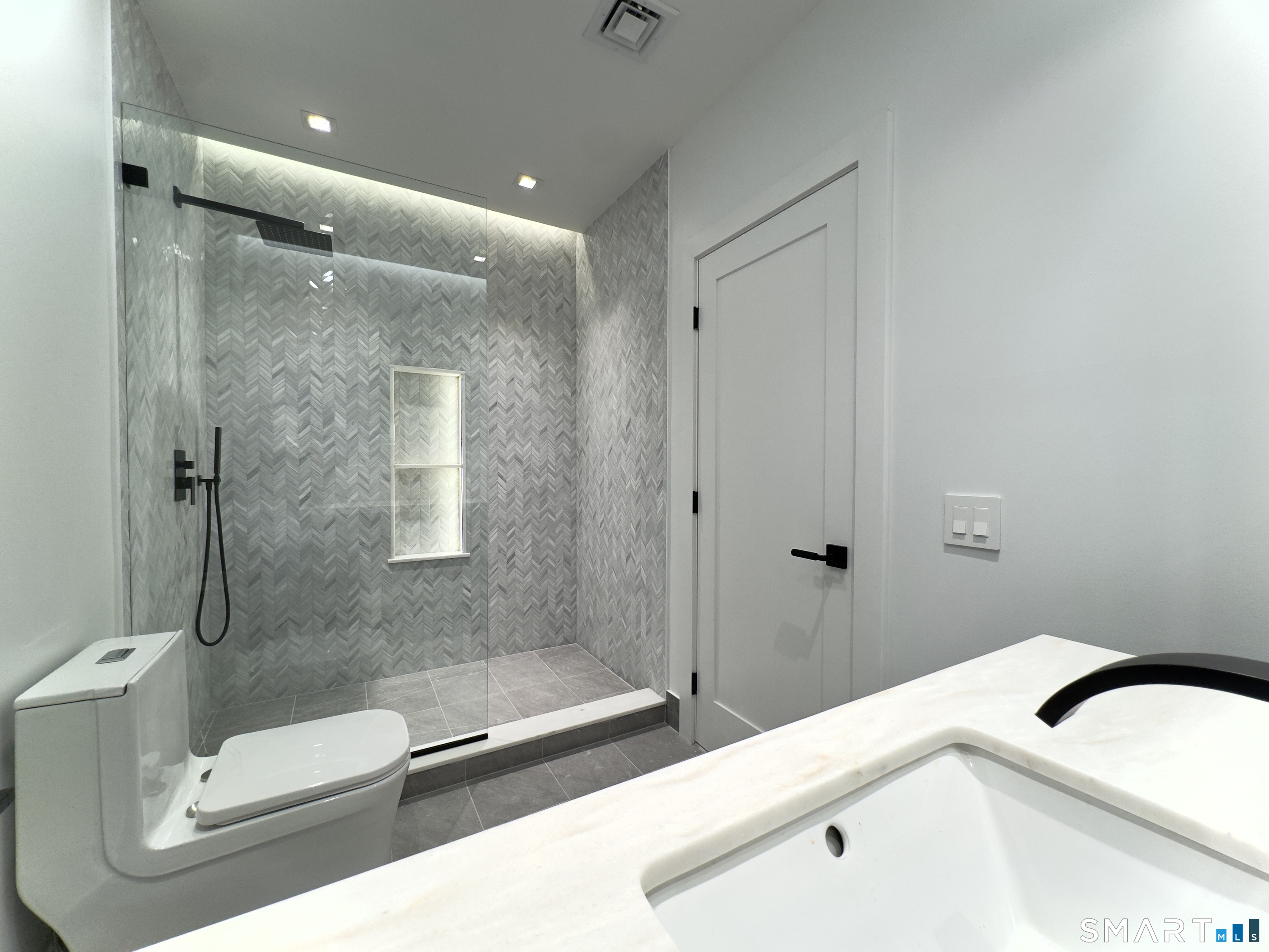 173 Belltown Road Stamford, CT 06905 - Photo 26 of 31 a bathroom with a sink a toilet and shower