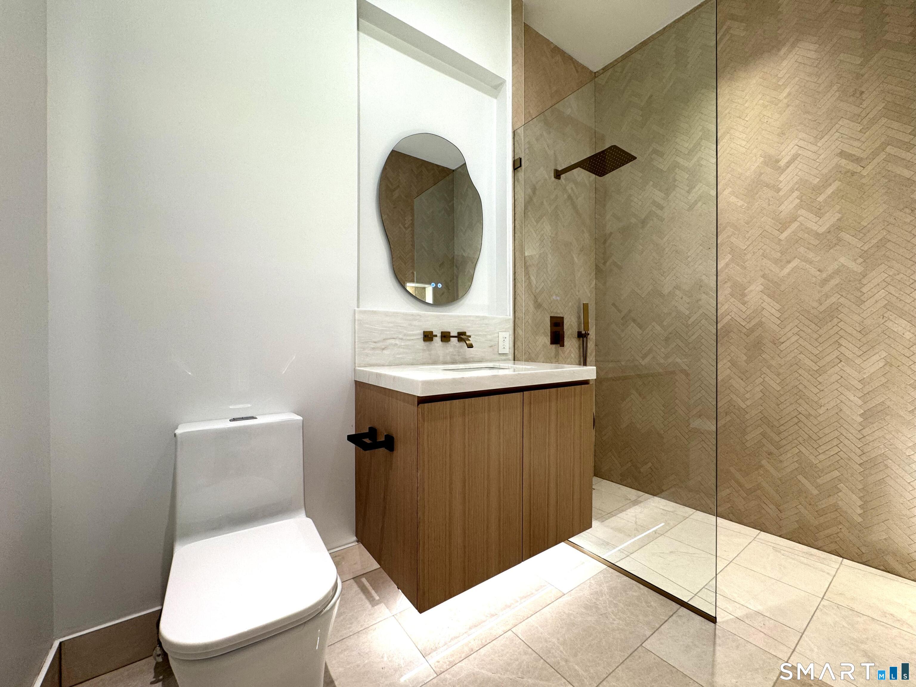 173 Belltown Road Stamford, CT 06905 - Photo 27 of 31 a bathroom with a toilet sink and mirror