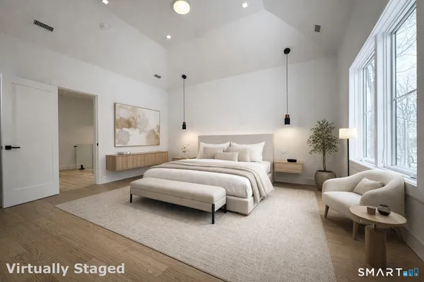 a spacious bedroom with a bed and window