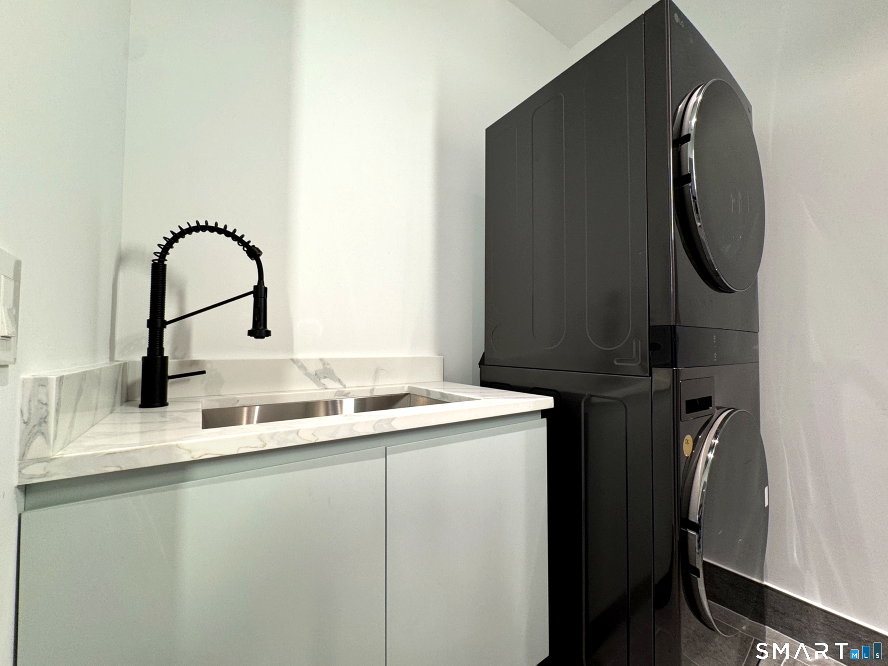 173 Belltown Road Stamford, CT 06905 - Photo 36 of 42 a bathroom with a sink and a mirror