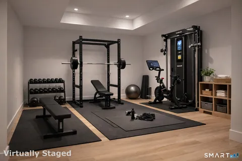 a room with gym equipment and a large mirror