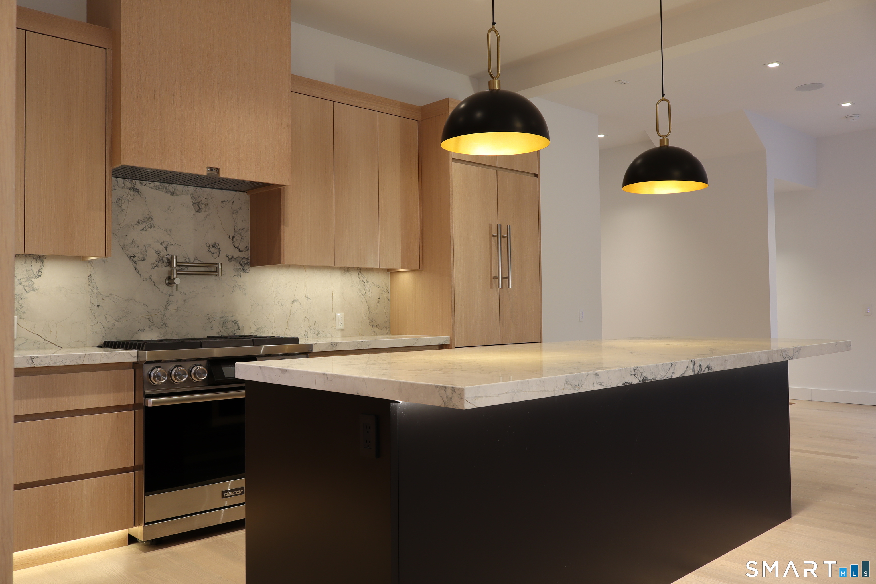 173 Belltown Road Stamford, CT 06905 - Photo 10 of 42 a kitchen with a stove and a wooden floor