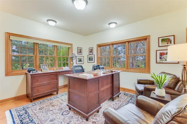 a living room with furniture and large windows