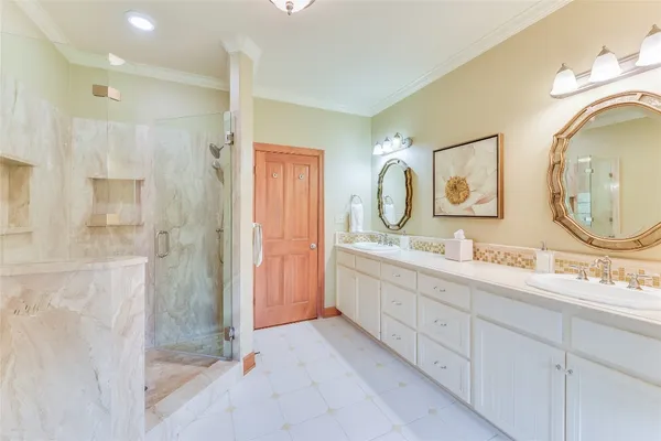 a spacious bathroom with a double vanity sink mirror and shower