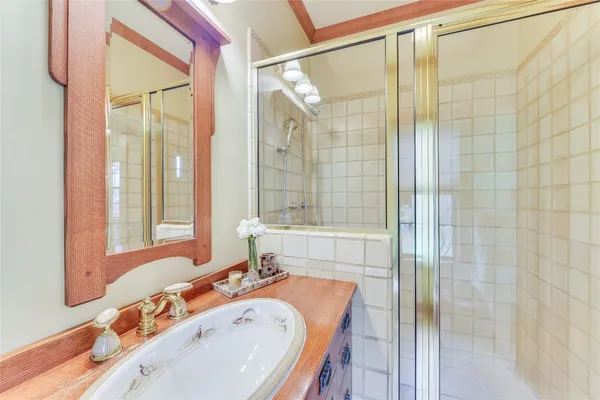 a bathroom with a tub sink and mirror