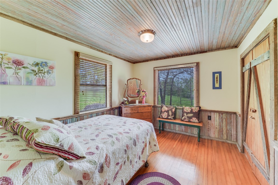 363 Paint Creek S Road, Unit A Paige, TX 78659 - Photo 28 of 40 a bedroom with a large bed couch and a window