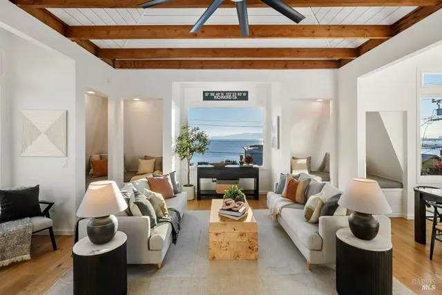 a living room with furniture flowerpot and wooden floor