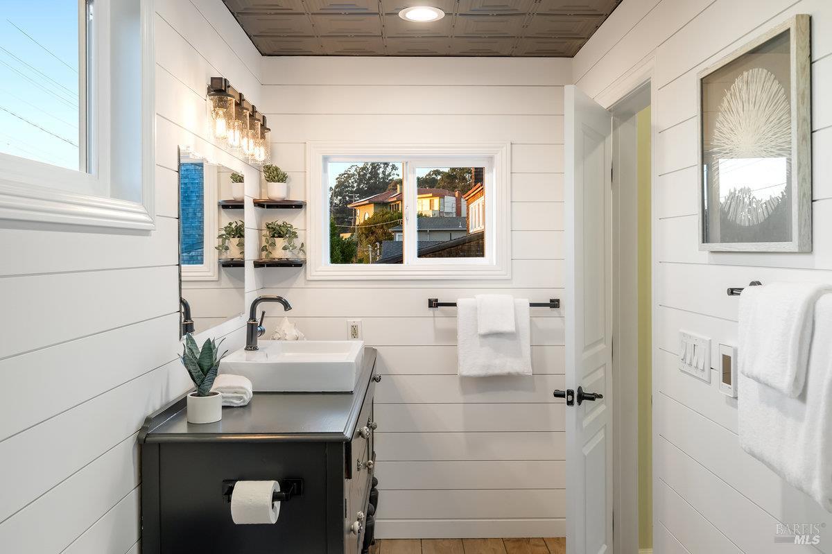 700 Ocean Avenue Point Richmond, CA 94801 - Photo 39 of 95 a bathroom with a sink a mirror and a window