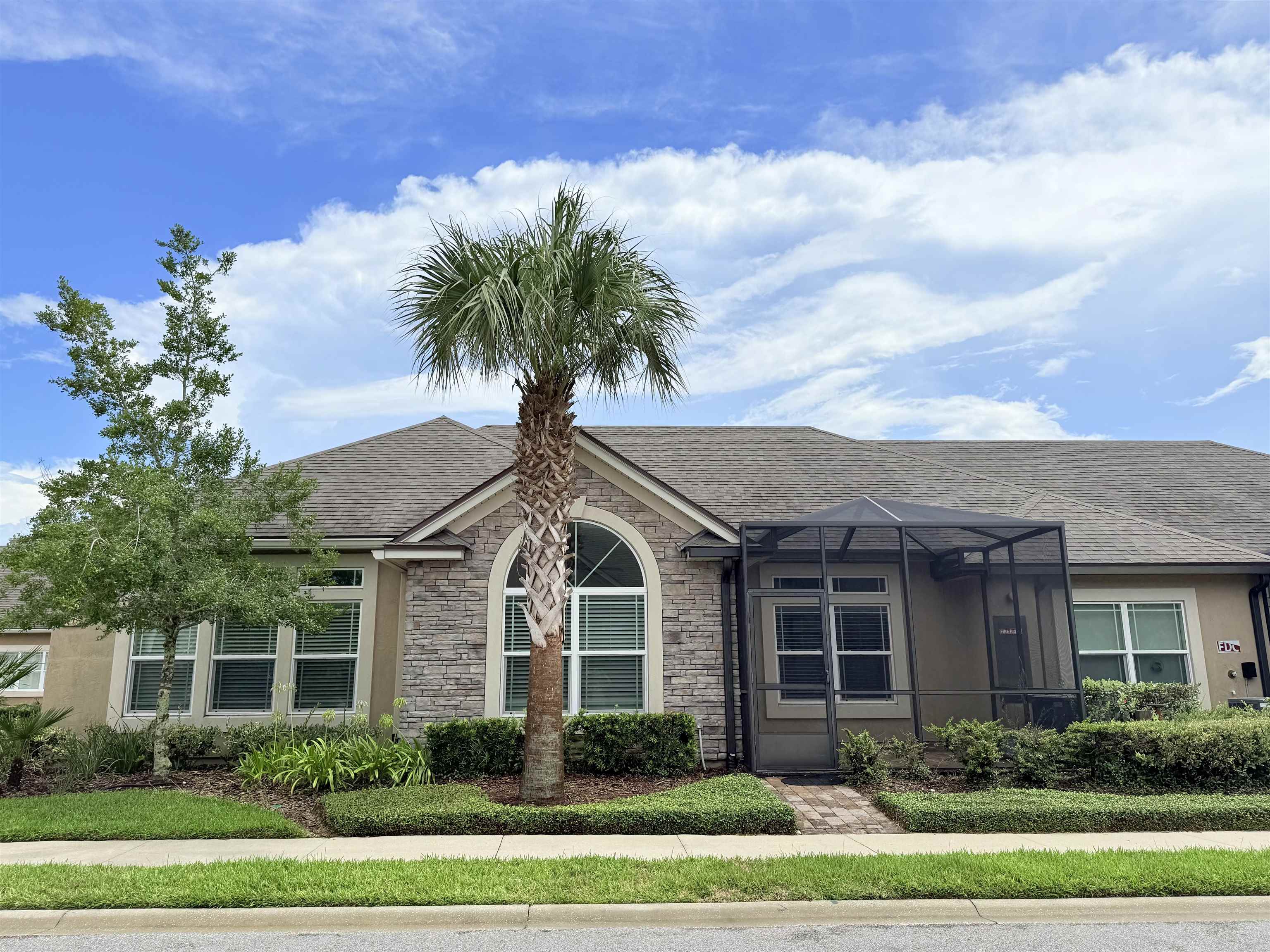 a front view of a house with a garden