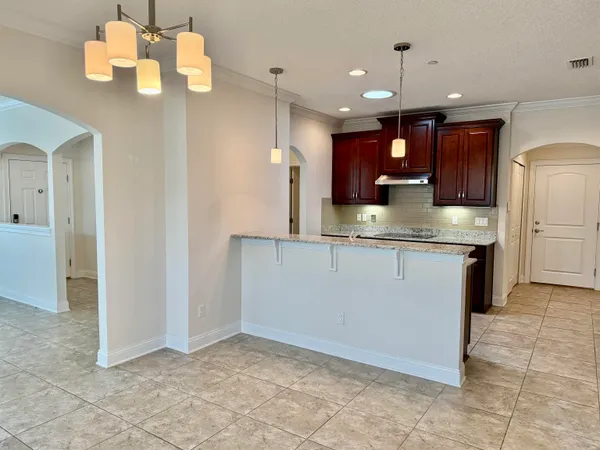 a kitchen with a sink counter top space cabinets and stainless steel appliances