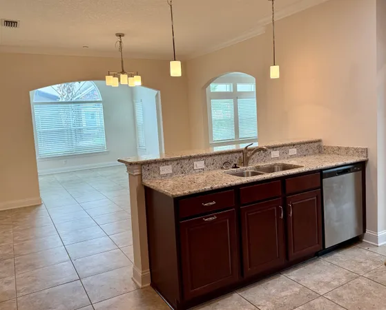 a bathroom with a granite countertop sink a toilet and a mirror