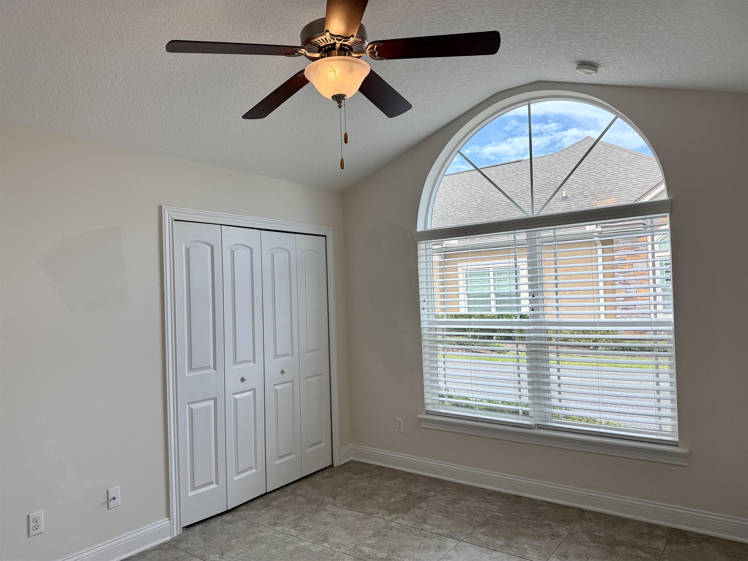 71 Utina Way St. Augustine, FL 32084 - Photo 17 of 37 an empty room with chandelier fan and windows