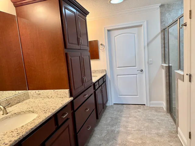 a bathroom with a glass shower door