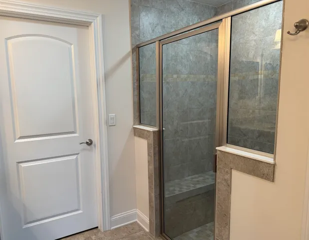 a white toilet sitting next to a white cabinet