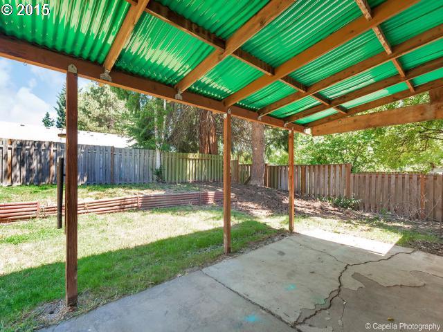19705 Southwest Prospect Lane Aloha, OR 97078 - Photo 15 of 16 a view of a backyard with a small cabin and wooden fence