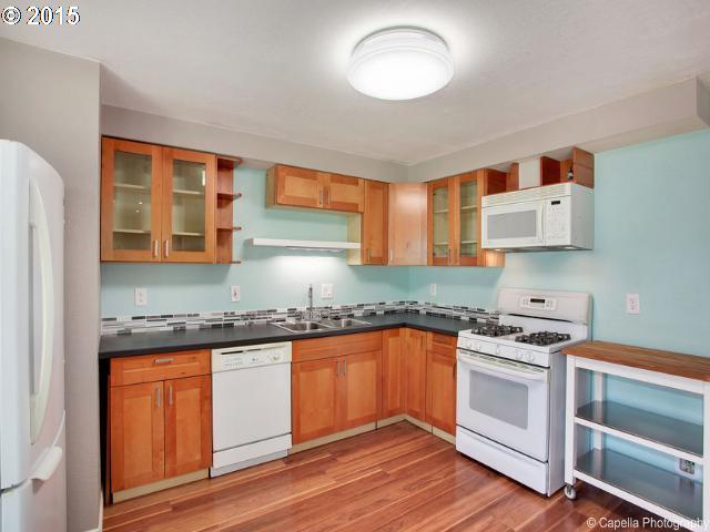 19705 Southwest Prospect Lane Aloha, OR 97078 - Photo 7 of 16 a kitchen with stainless steel appliances granite countertop a stove and a sink