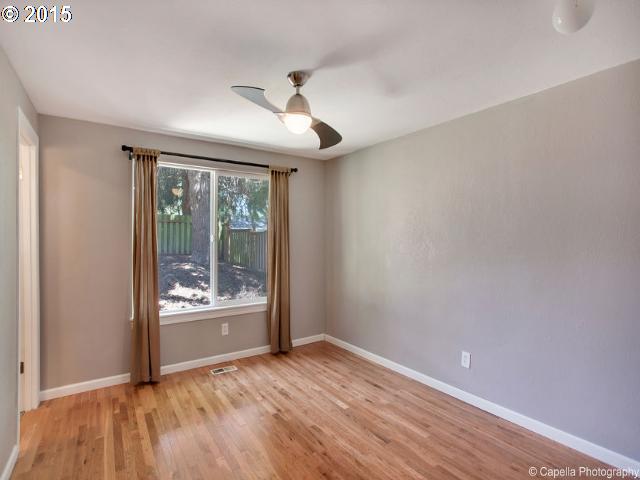 19705 Southwest Prospect Lane Aloha, OR 97078 - Photo 8 of 16 wooden floor in an empty room with a window