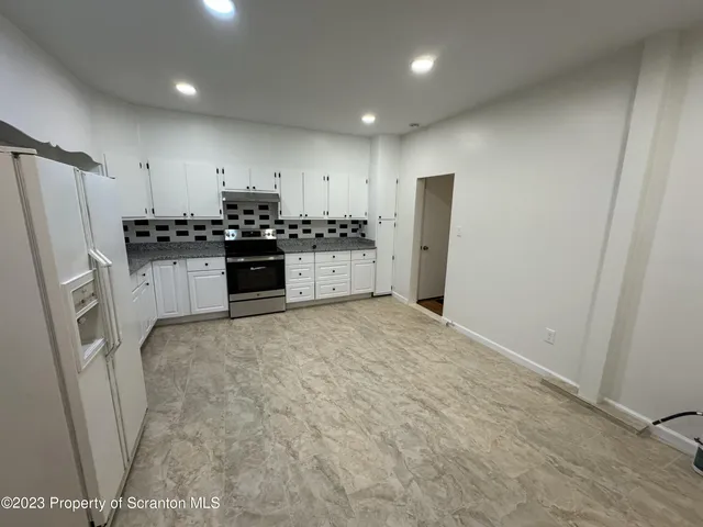 a kitchen with stainless steel appliances a refrigerator and a sink
