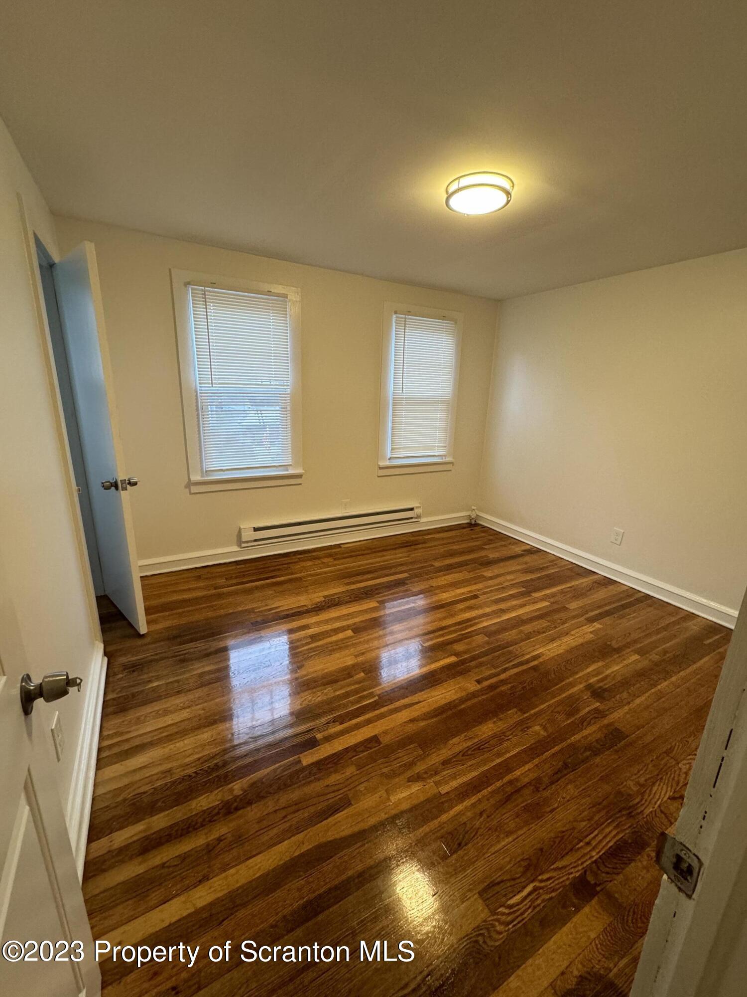 318 1/2 14th Avenue Scranton, PA 18504 - Photo 7 of 10 a view of empty room with wooden floor and fan