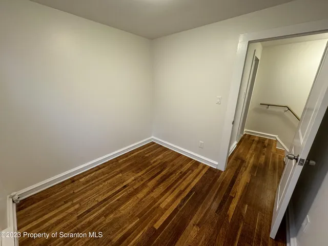 a view of room with wooden floor