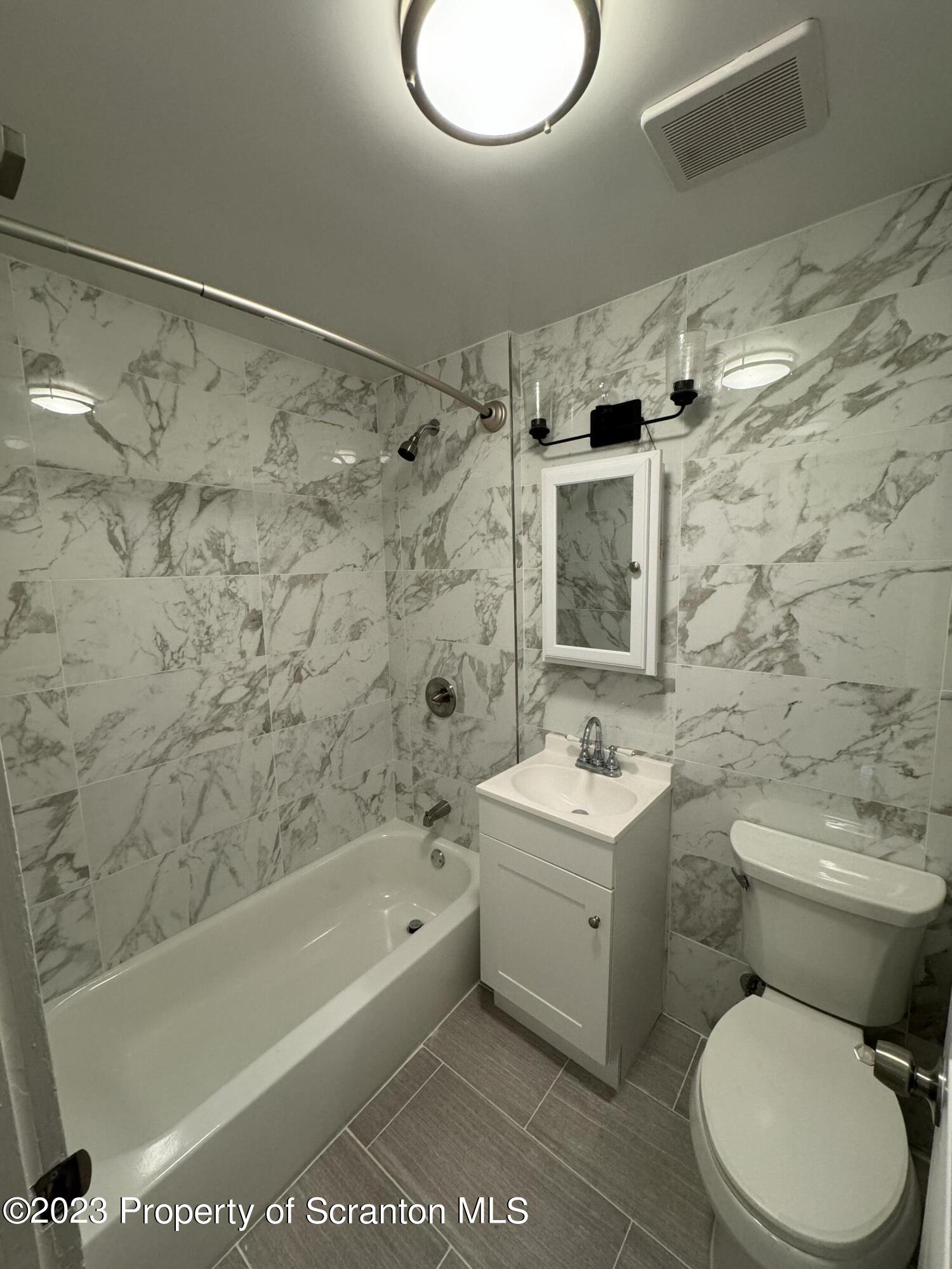 318 1/2 14th Avenue Scranton, PA 18504 - Photo 10 of 10 a bathroom with a sink toilet and shower