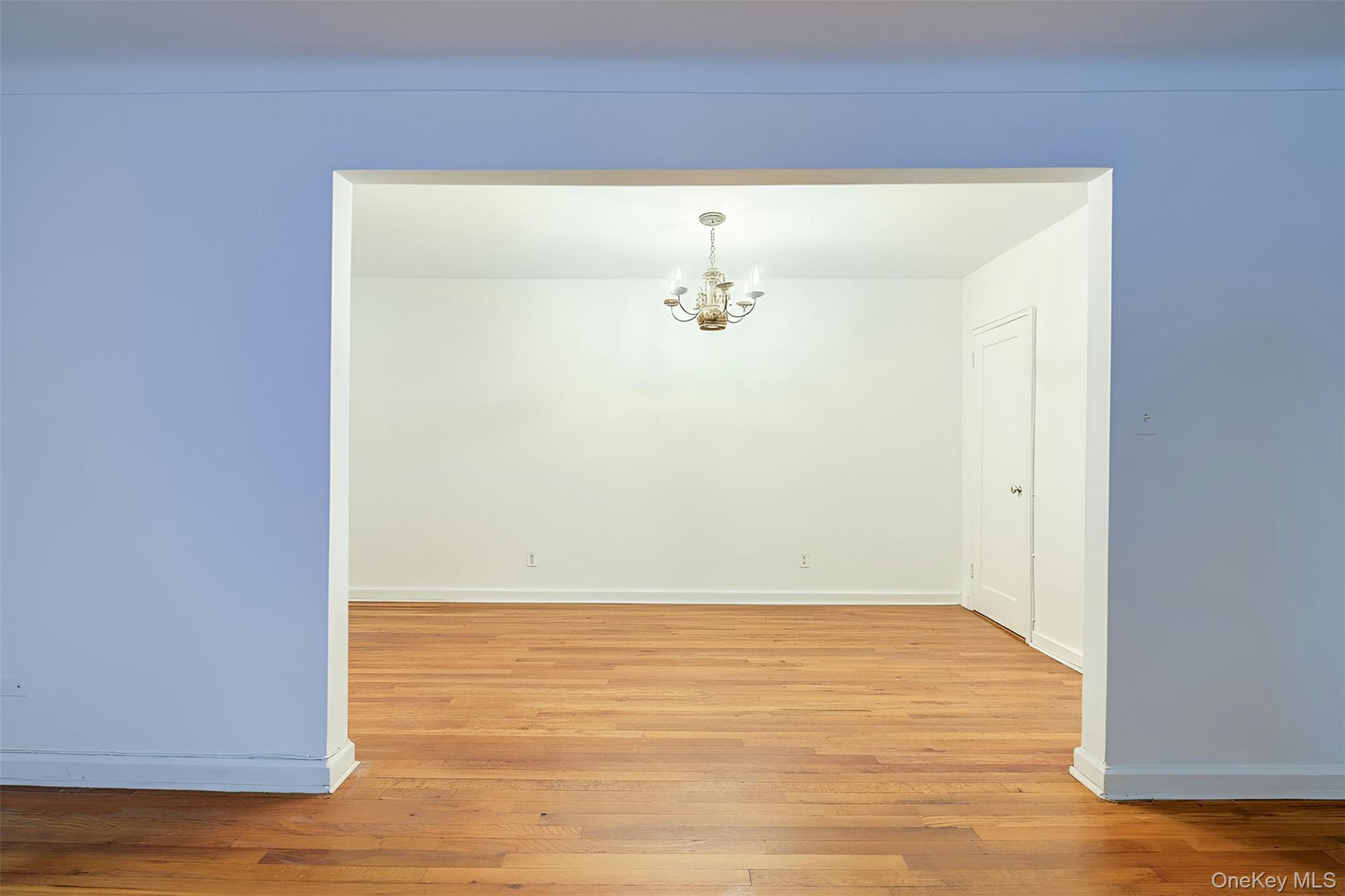 67-12 Yellowstone Boulevard, Unit D9 Queens, NY 11375 - Photo 12 of 36 a view of an empty room with wooden floor
