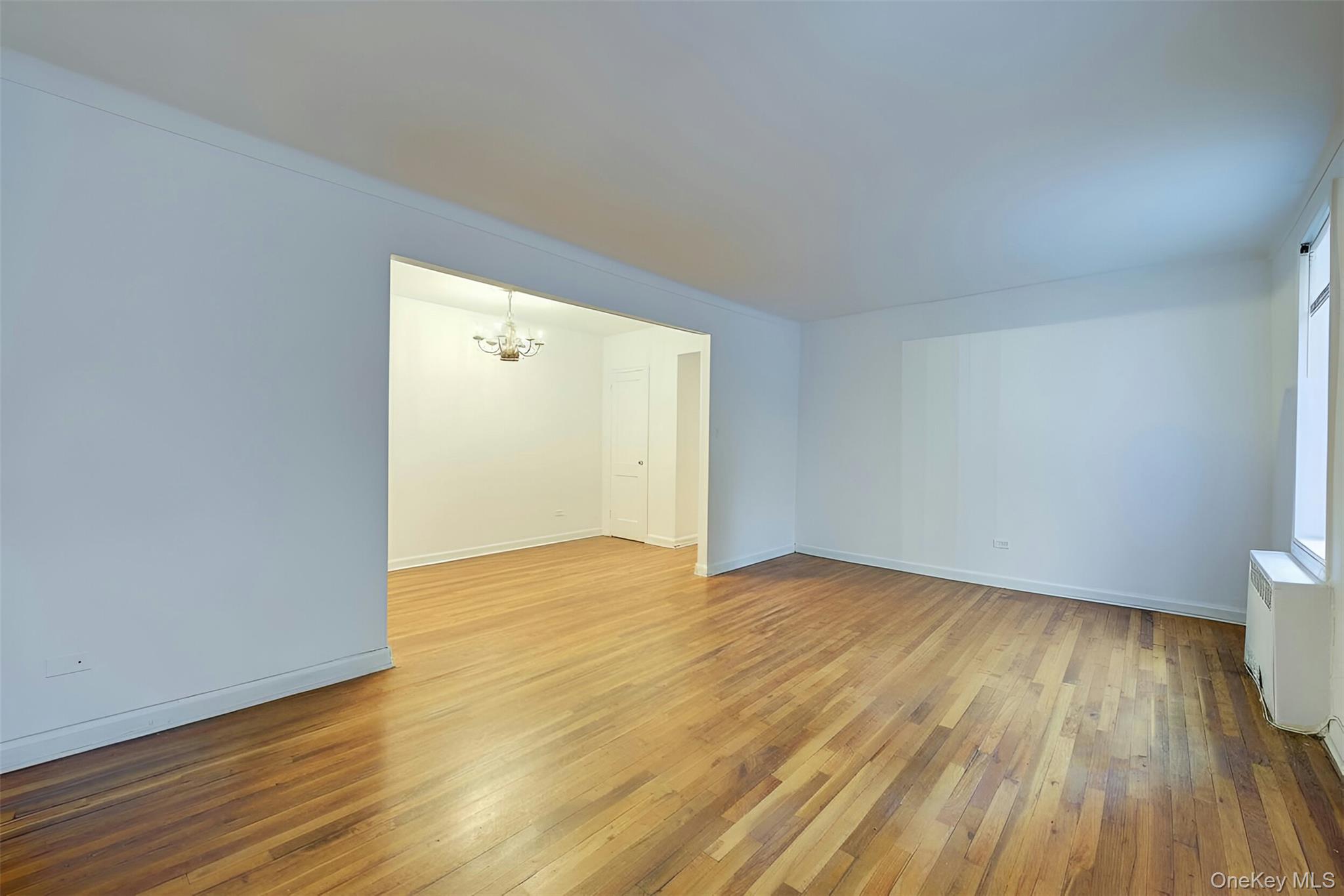 67-12 Yellowstone Boulevard, Unit D9 Queens, NY 11375 - Photo 2 of 36 a view of an empty room and wooden floor