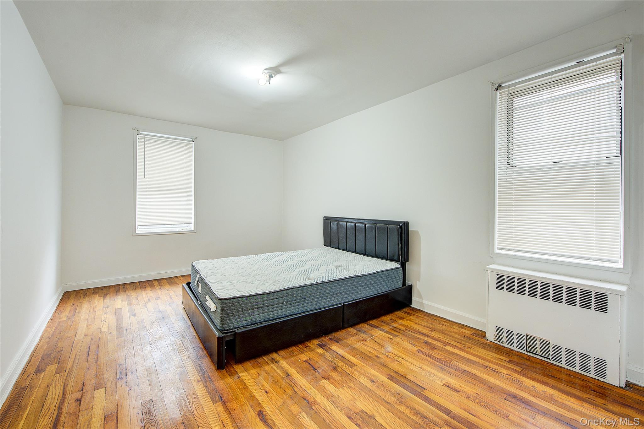 67-12 Yellowstone Boulevard, Unit D9 Queens, NY 11375 - Photo 23 of 36 a bedroom with a bed and a window