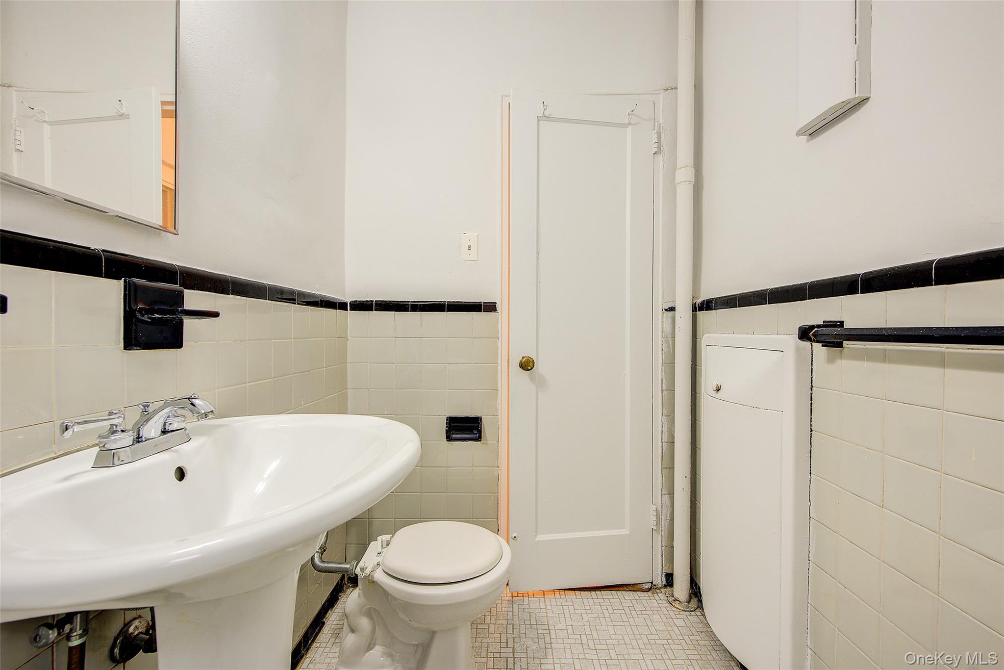 67-12 Yellowstone Boulevard, Unit D9 Queens, NY 11375 - Photo 26 of 36 a bathroom with a sink and a toilet
