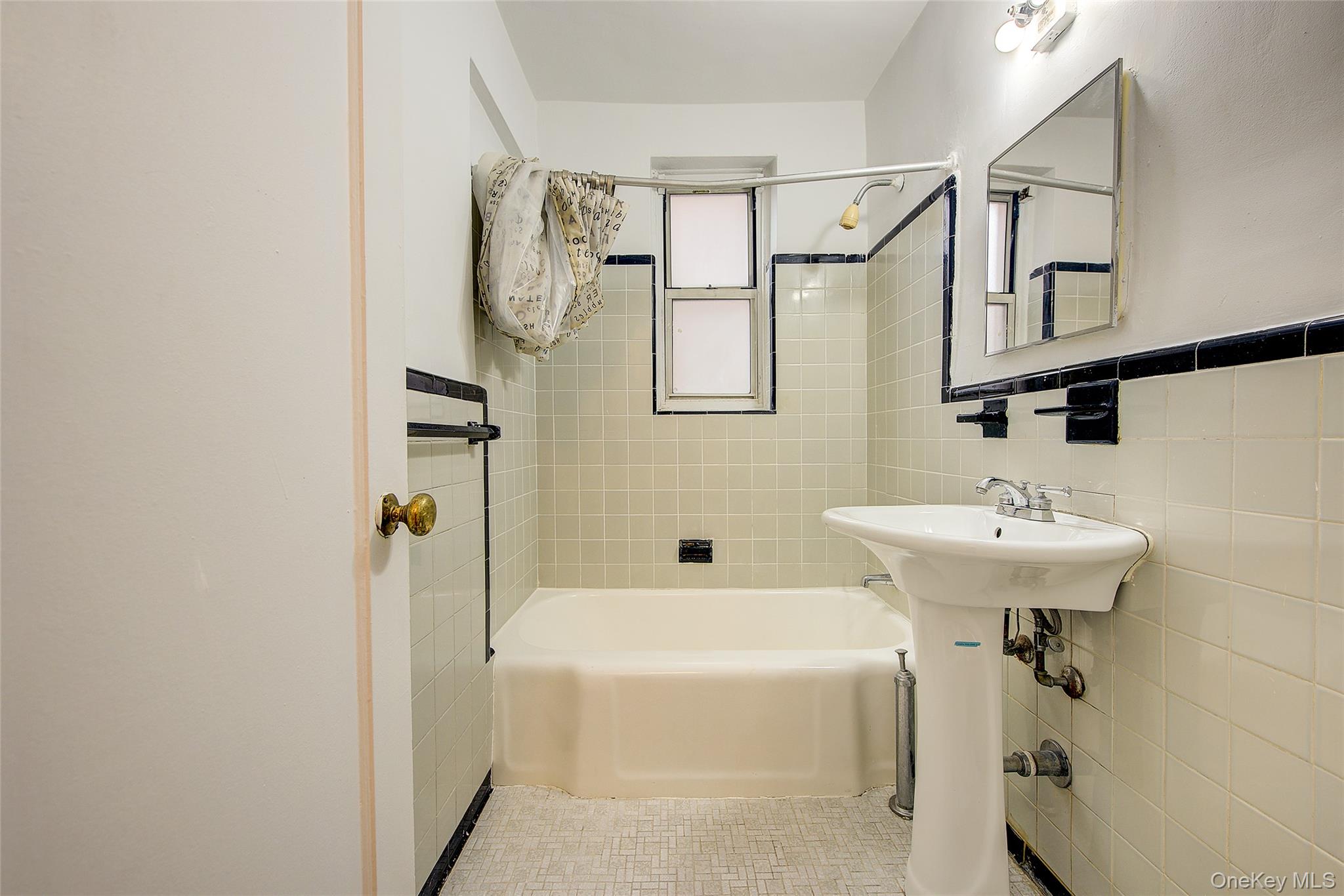 67-12 Yellowstone Boulevard, Unit D9 Queens, NY 11375 - Photo 27 of 36 a bathroom with a sink a toilet and shower