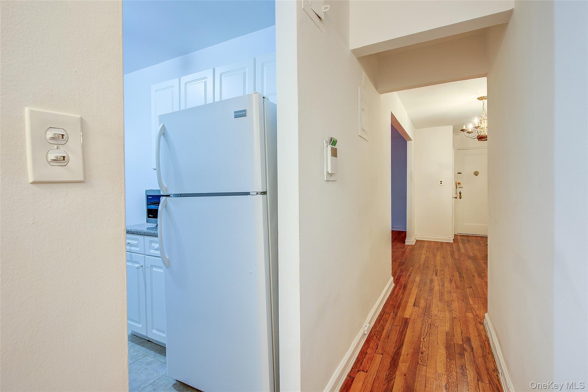 67-12 Yellowstone Boulevard, Unit D9 Queens, NY 11375 - Photo 28 of 36 a view of a bedroom with wooden floor and hallway
