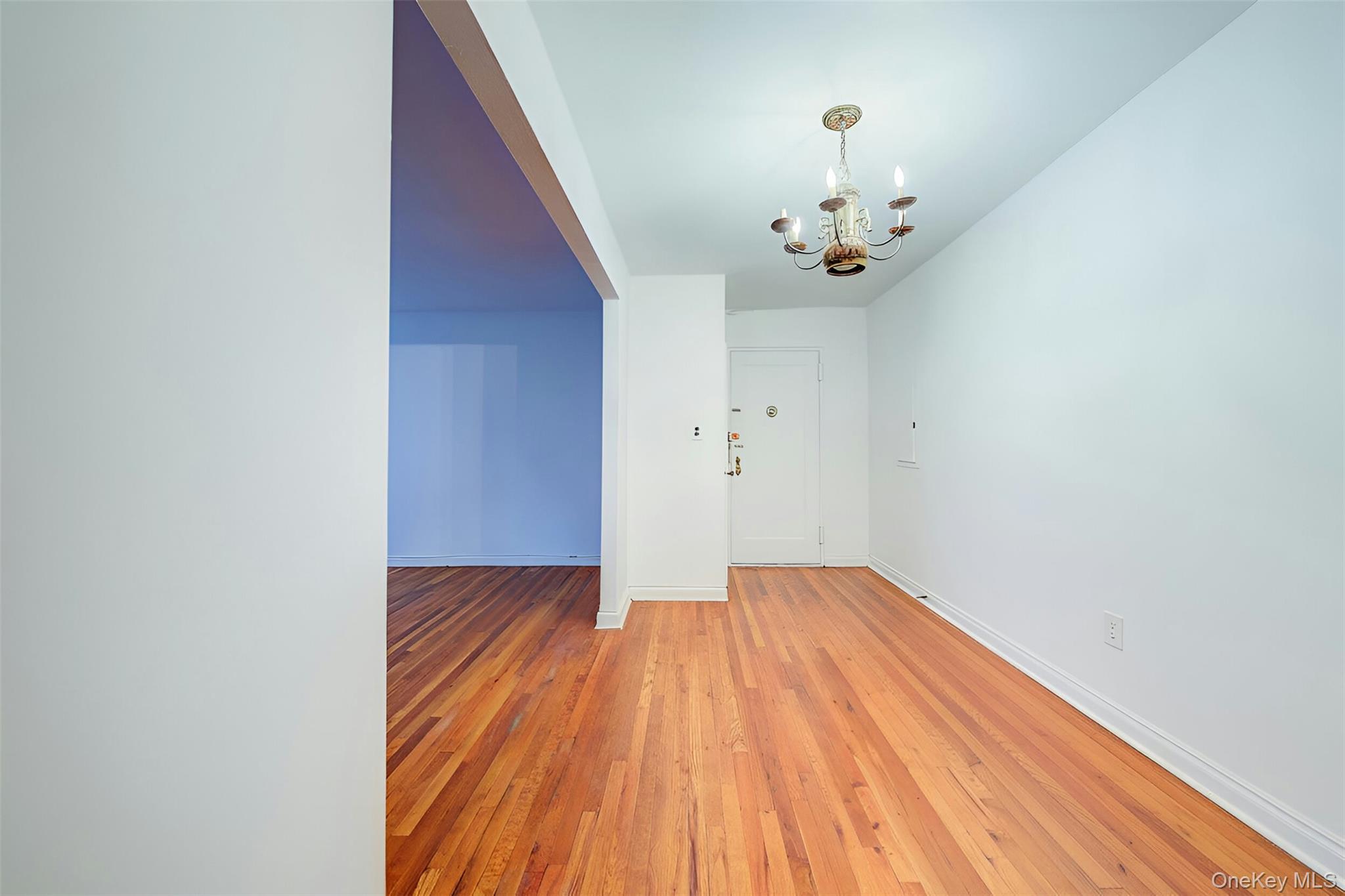 67-12 Yellowstone Boulevard, Unit D9 Queens, NY 11375 - Photo 30 of 36 a view of an empty room with wooden floor