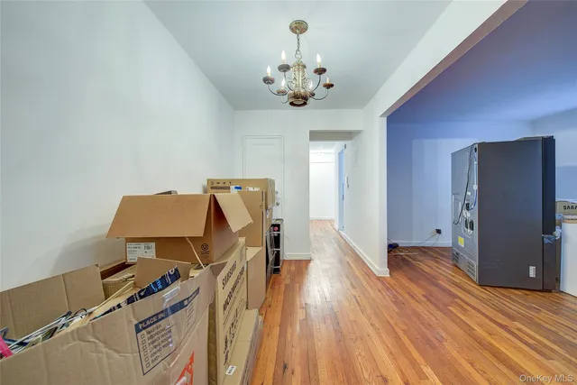 a view of a workspace with furniture and a chandelier