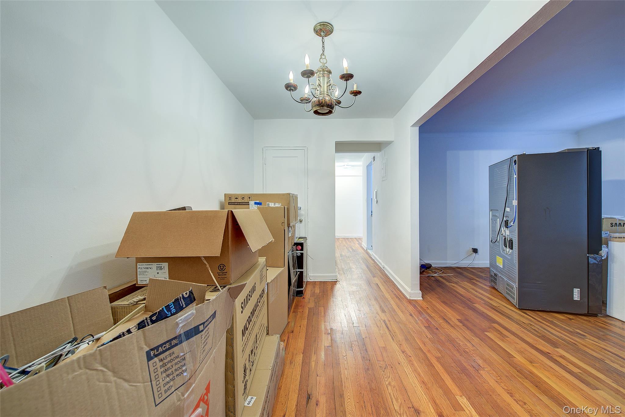 67-12 Yellowstone Boulevard, Unit D9 Queens, NY 11375 - Photo 5 of 36 a view of a workspace with furniture and a chandelier