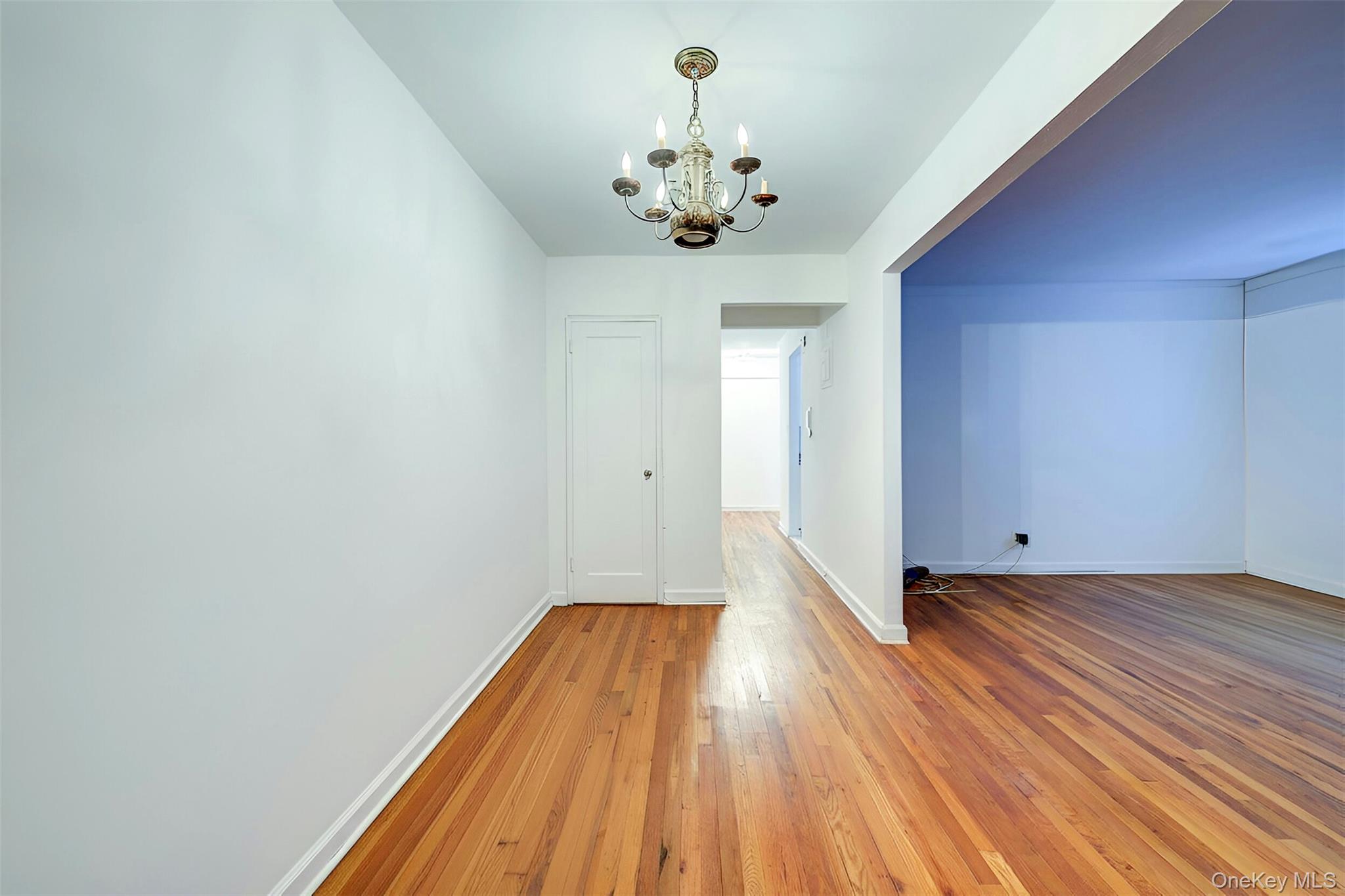 67-12 Yellowstone Boulevard, Unit D9 Queens, NY 11375 - Photo 6 of 36 a view of a room with wooden floor and chandelier