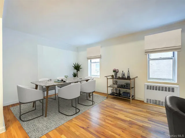 a living room with furniture a window and a table