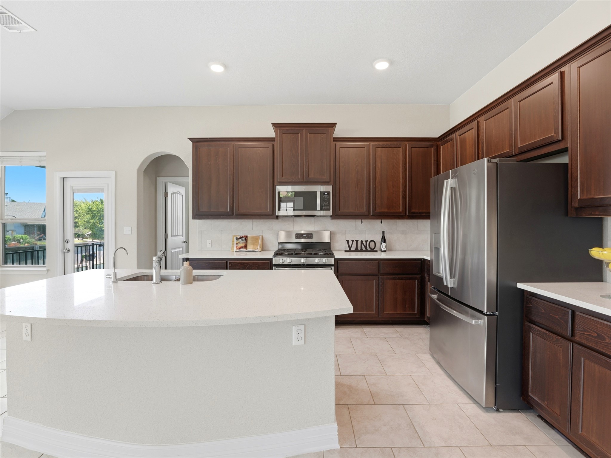 2132 Ringstaff Road Leander, TX 78641 - Photo 8 of 39 An inviting kitchen with rich cabinetry and an expansive island awaits culinary adventures.