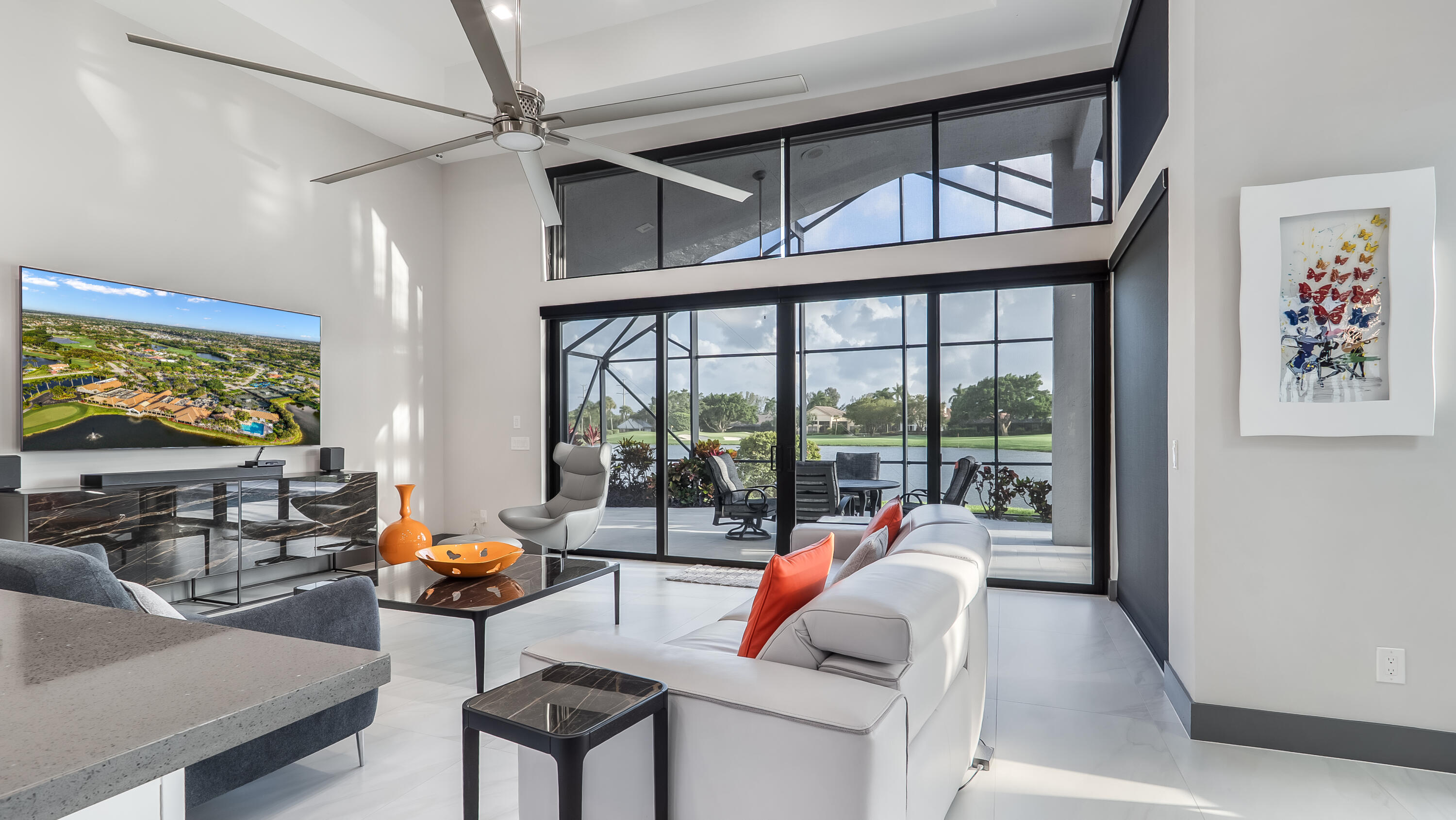 17683 Sealakes Drive Boca Raton, FL 33498 - Photo 20 of 61 a living room with furniture a floor to ceiling window and a flat screen tv