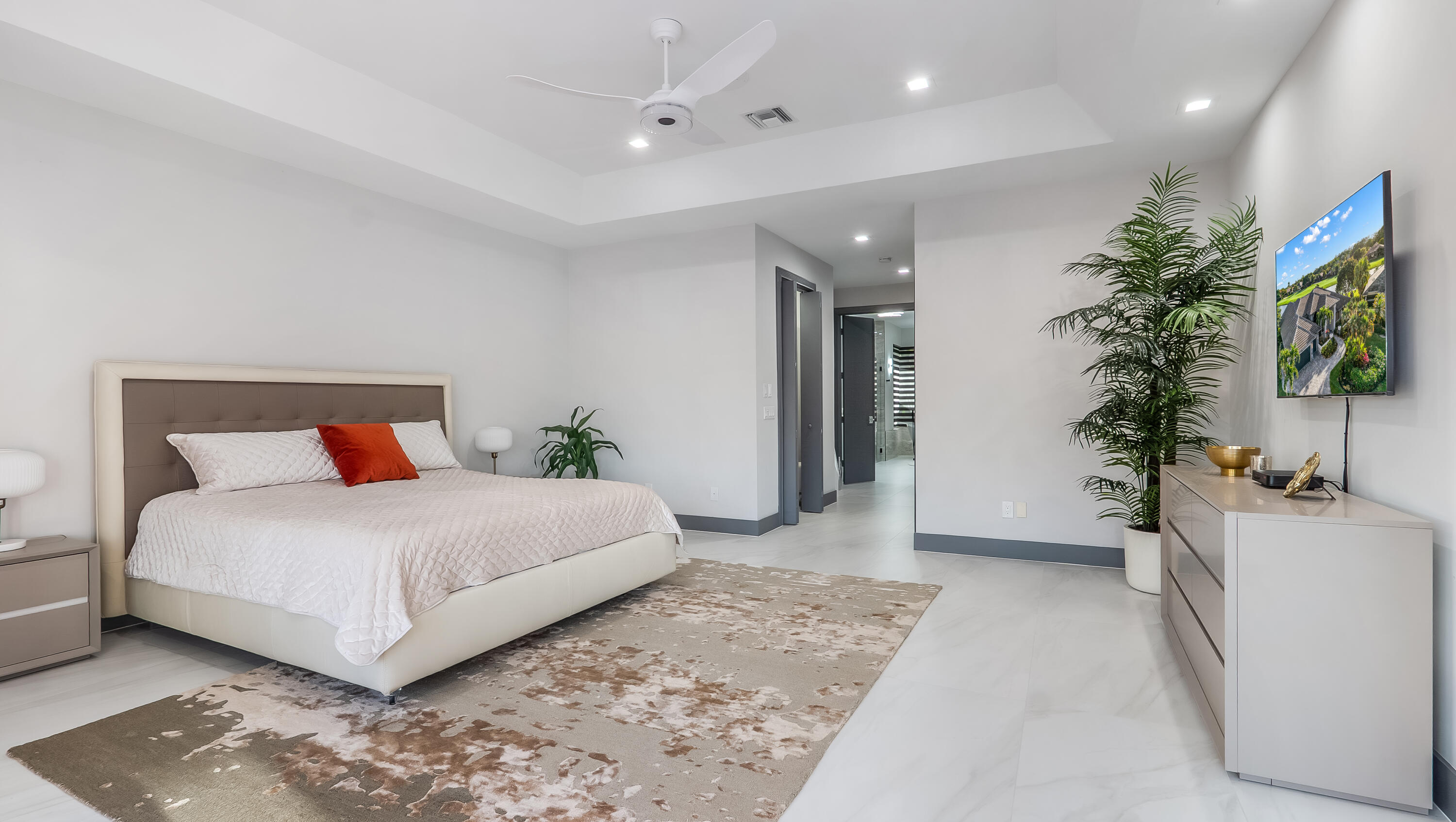 17683 Sealakes Drive Boca Raton, FL 33498 - Photo 30 of 61 a bedroom with a large bed and a flat tv screen