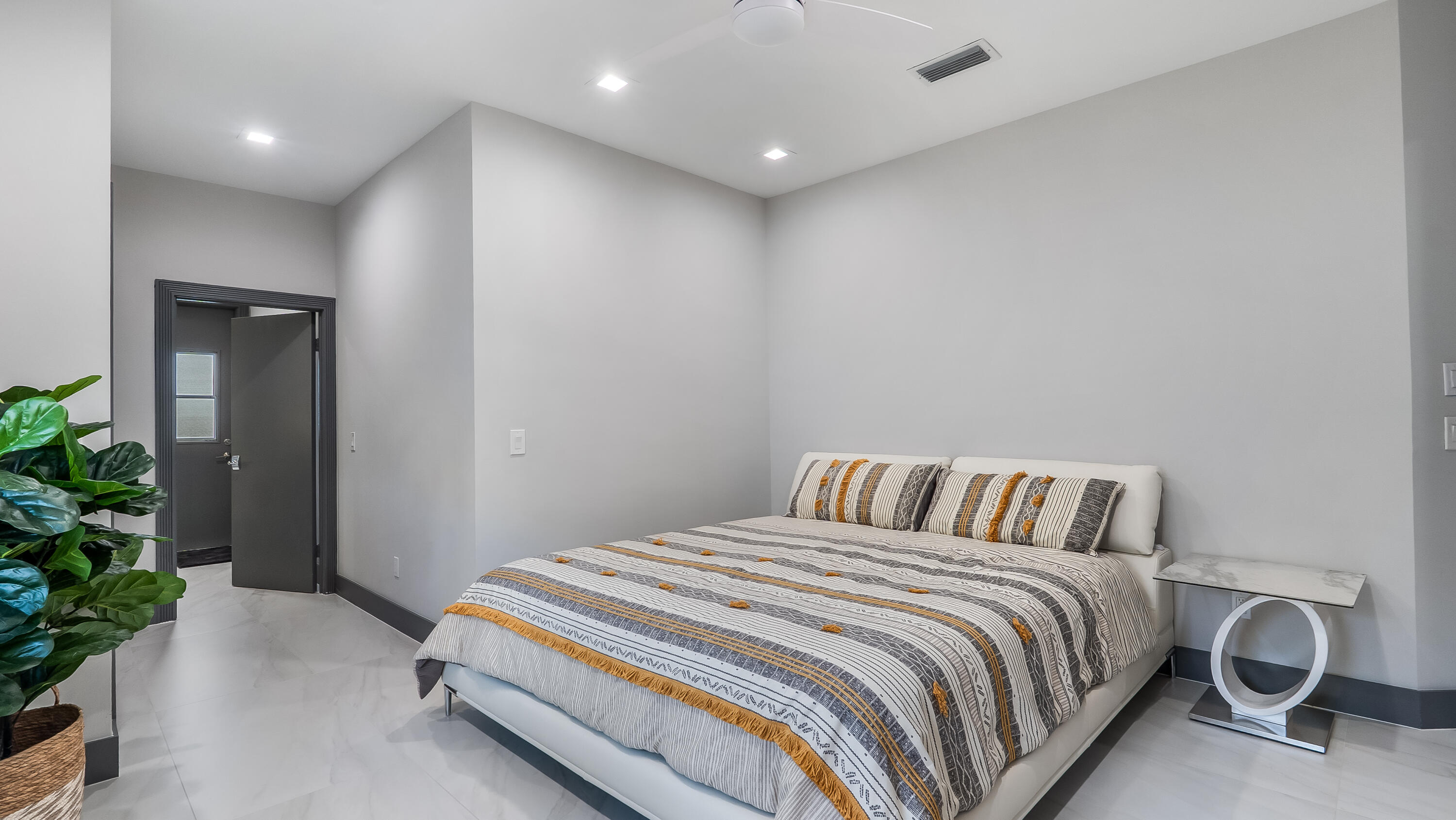 17683 Sealakes Drive Boca Raton, FL 33498 - Photo 35 of 61 a bedroom with a bed and a potted plant