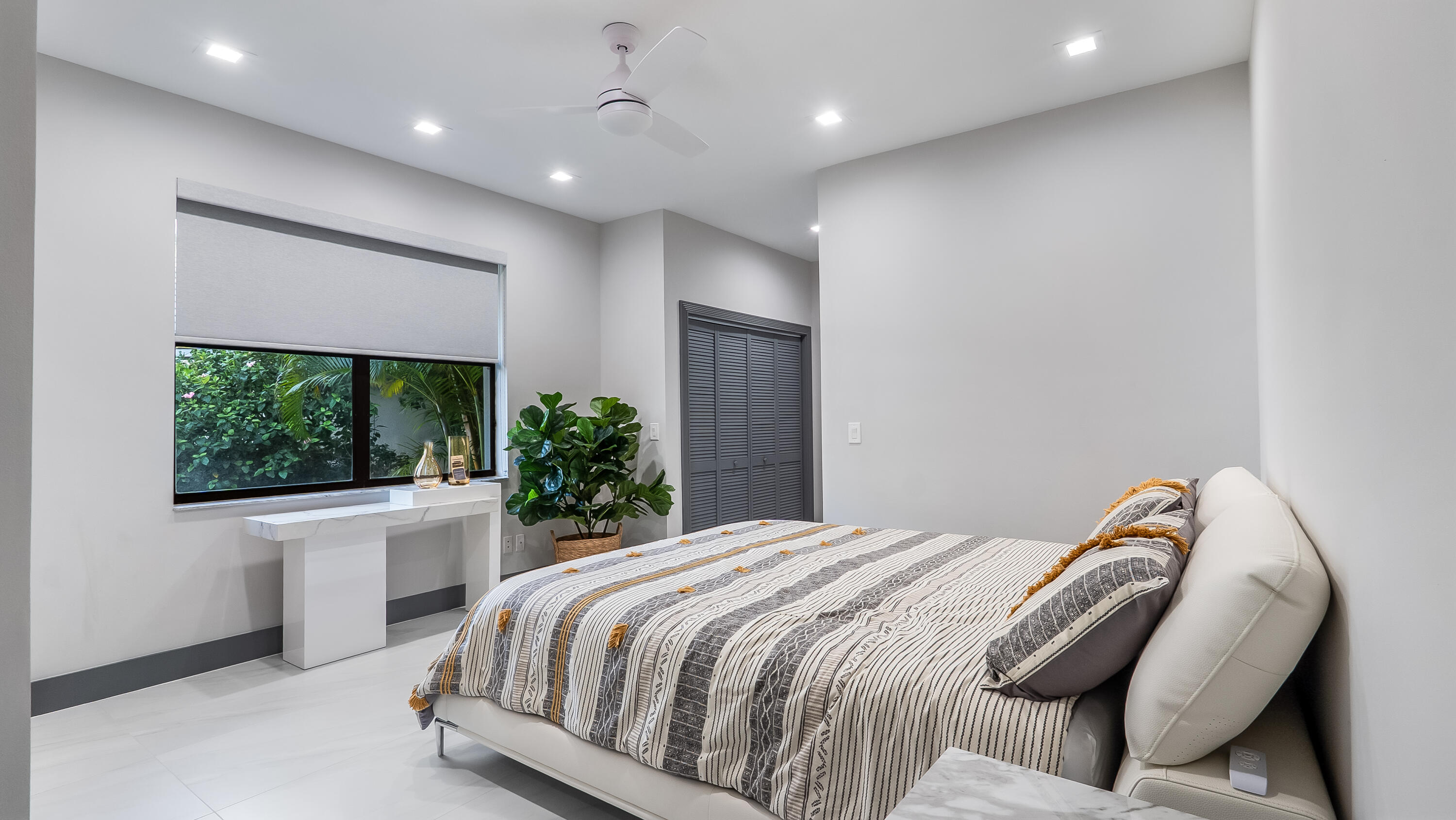 17683 Sealakes Drive Boca Raton, FL 33498 - Photo 36 of 61 a spacious bedroom with a bed and a window