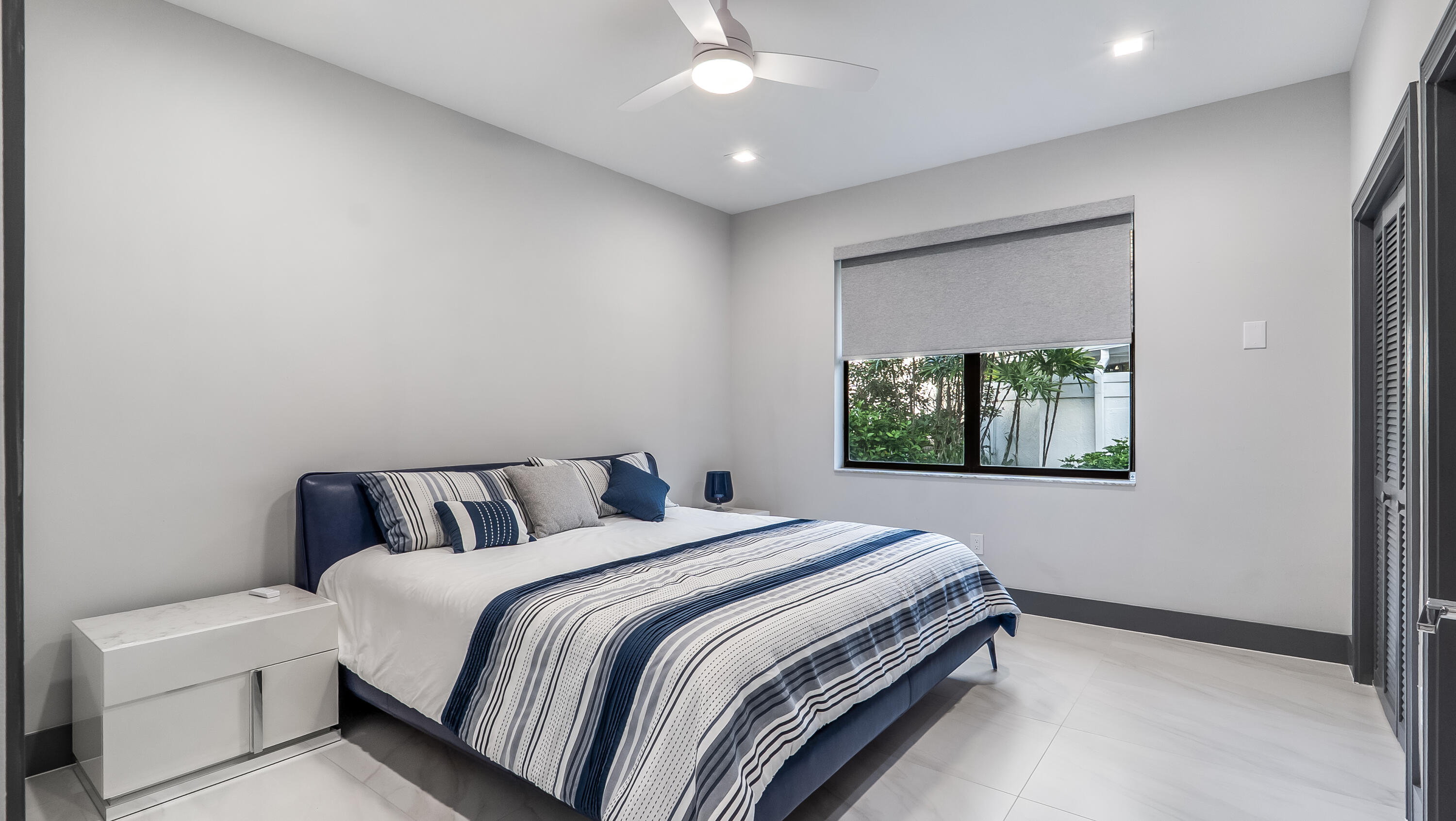 17683 Sealakes Drive Boca Raton, FL 33498 - Photo 40 of 61 a bedroom with a bed and a window