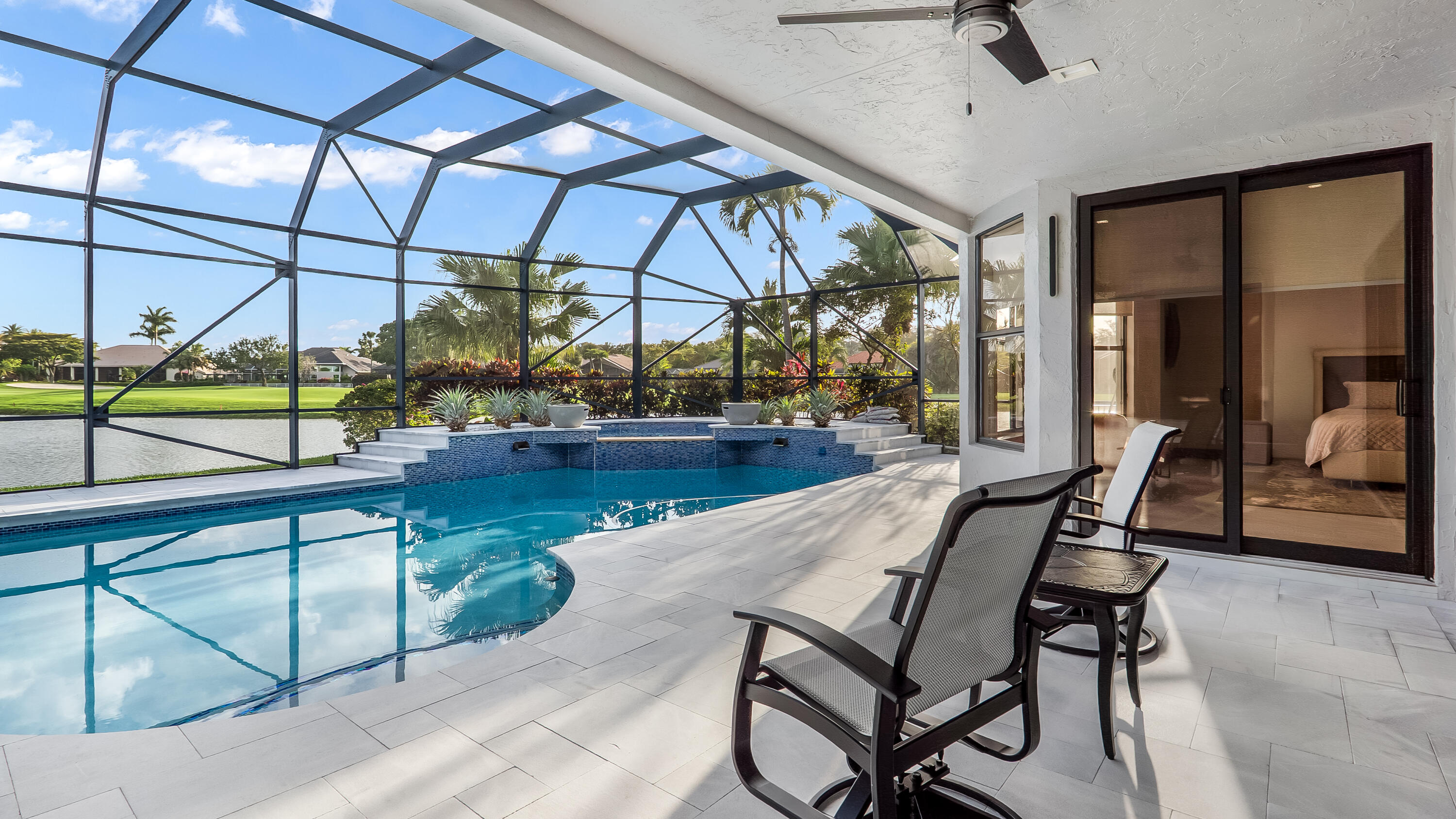 17683 Sealakes Drive Boca Raton, FL 33498 - Photo 56 of 61 a view of a swimming pool with a chair and tables in patio