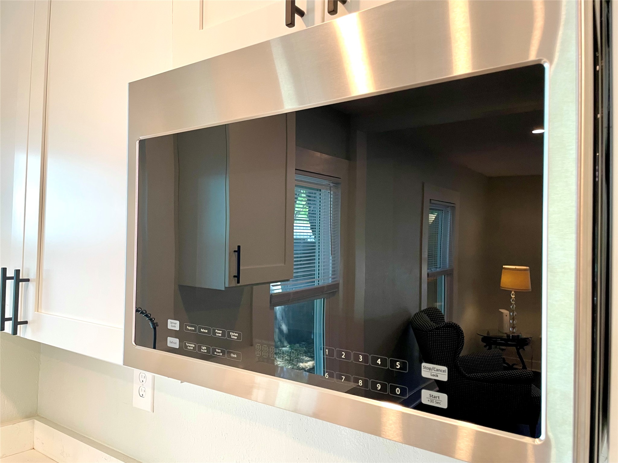 807 East Riverside Drive, Unit B Austin, TX 78704 - Photo 15 of 28 Streamlined kitchen design features a built-in microwave, seamlessly integrating into the cabinetry for a polished aesthetic.