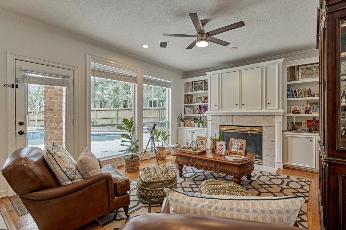 91 Wind Ridge Circle The Woodlands, TX 77381 - Photo 14 of 50 Note the smart built-ins that add richness to this living area along with large picture windows.